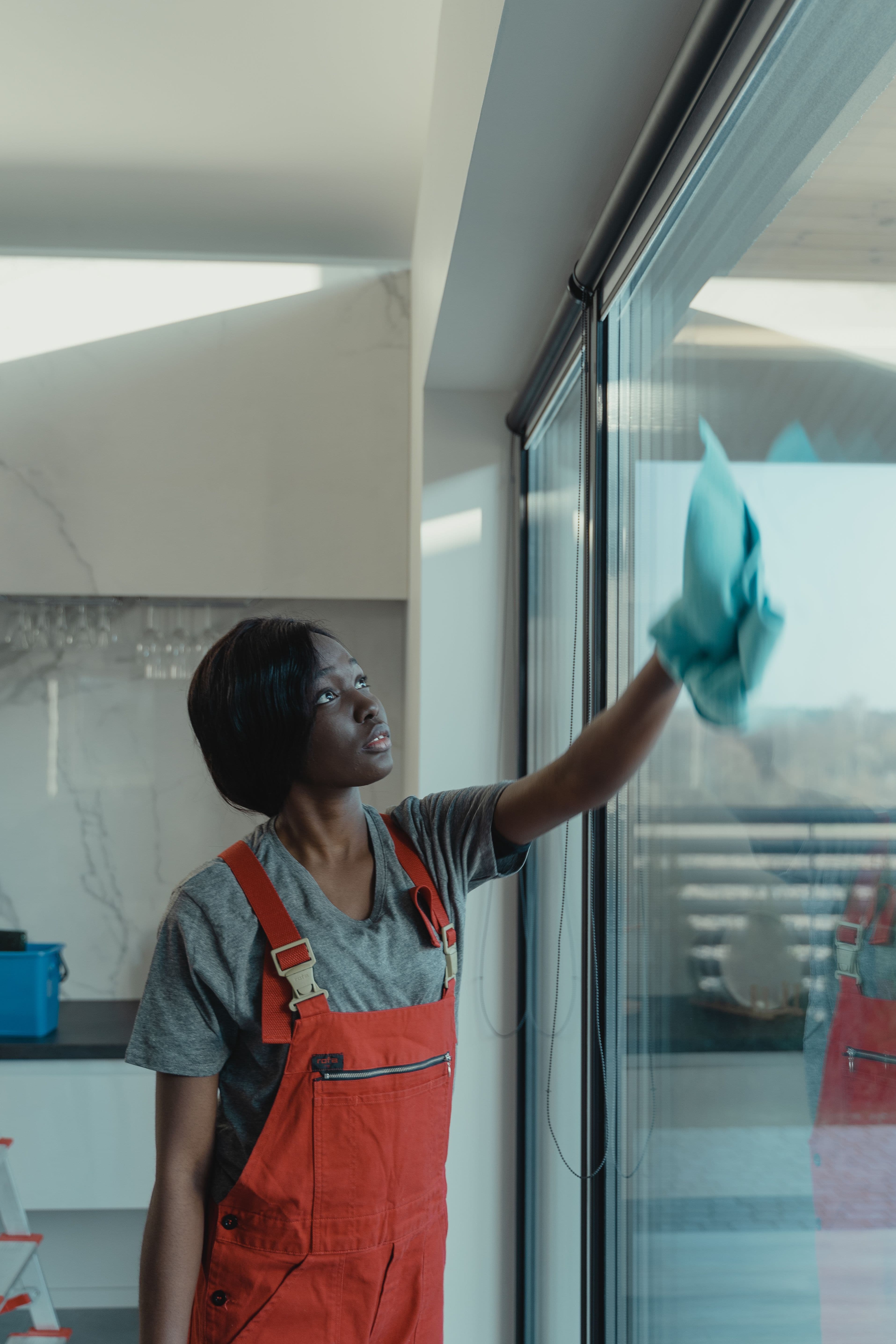 Professional cleaner wiping a glass window